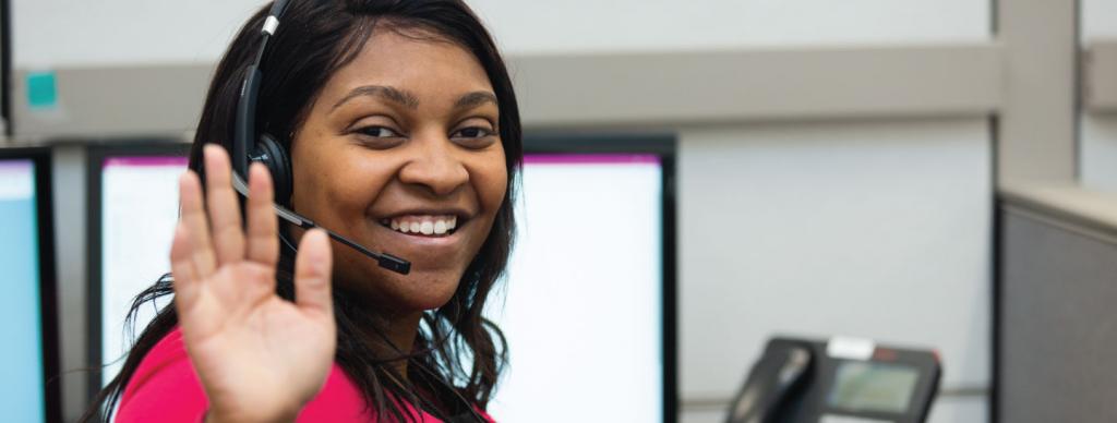 Woman from United Way of Greater Cincinnati 211 call center waving and smiling