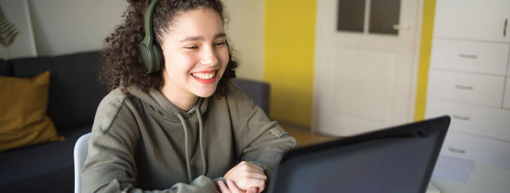 Teen smiling while using laptop computer