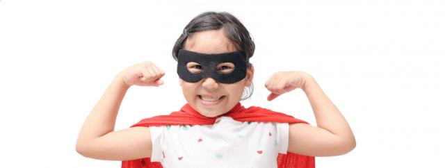 Little girls in super-hero suit showing muscles