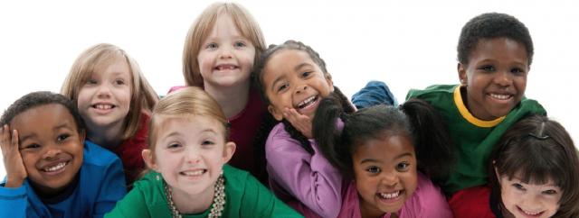 A group of children posed together smiling