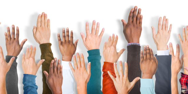 Image of diverse people raising their hands