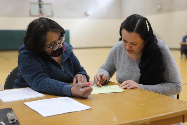A free tax prep volunteer assists a client with her 2022 tax return