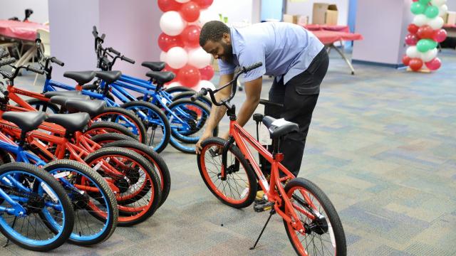 United Way employee assembling a donated bike for Adopt-A-Family program
