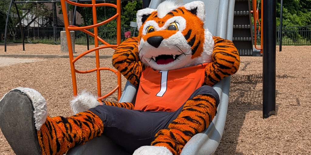 Cincinnati Bengals mascot Who Dey, on playground slide at the Hometown Huddle.