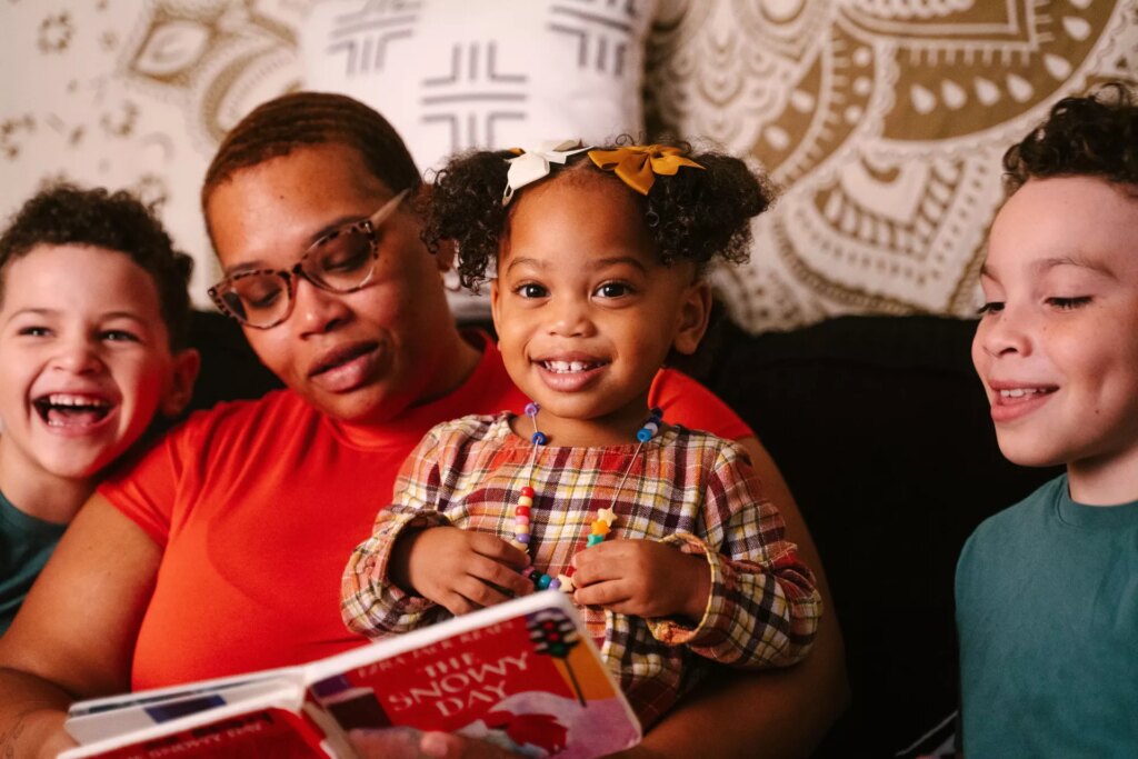 Brittany Berry, reads with her children, from left, De'Andre, Sunshine and Ryan.