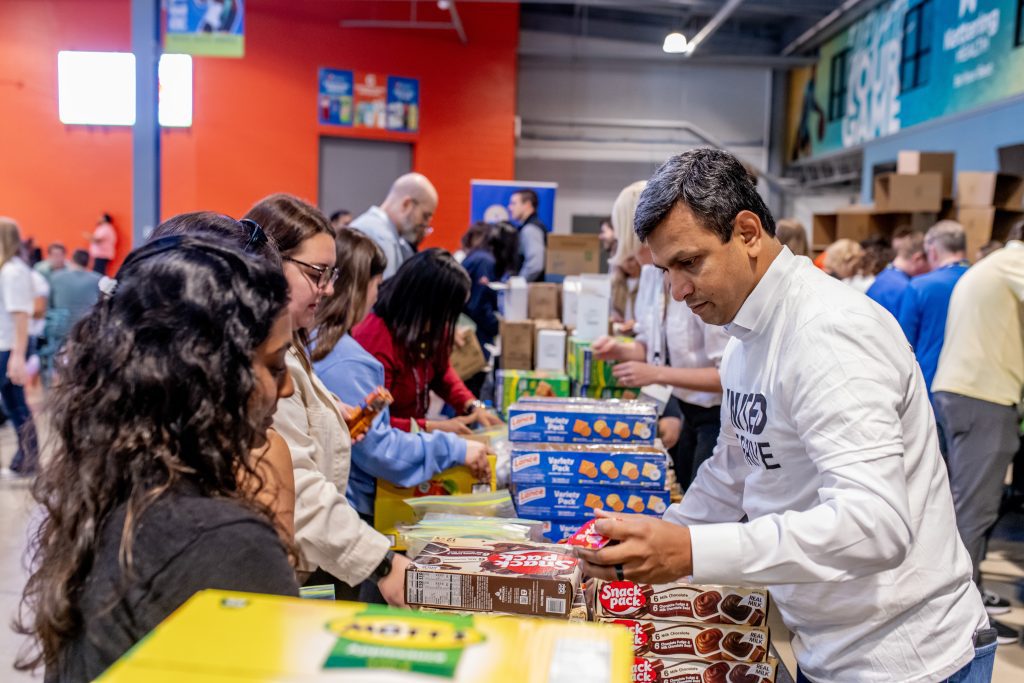 Volunteers assembling snack packs